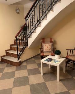 a living room with a staircase and a table at Casa Ancá Los Abuelos in Rute +9 photos
