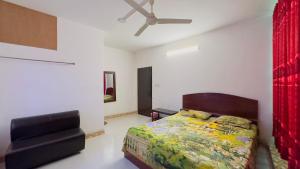 a bedroom with a bed and a ceiling fan at Hotel Priyatama Residential in Dhaka