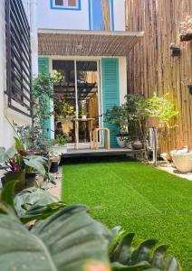 a yard with green grass and a house at Balai Lawaan Cozy Homestay in Iloilo City