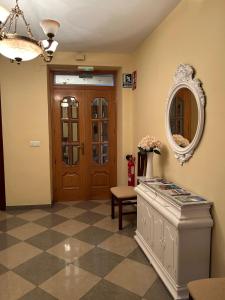 a hallway with a door and a mirror and a table at Casa Ancá Los Abuelos in Rute