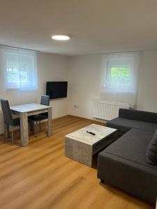 a living room with a couch and a table at Ferienwohnungen in Heidenheim in Heidenheim