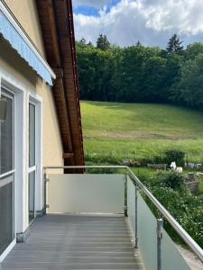 a balcony of a house with a view of a field at Lichtdurchflutete 130qm Wohnung in Weißenohe