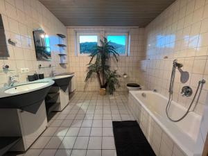 a bathroom with a tub and a sink and a toilet at Lichtdurchflutete 130qm Wohnung in Weißenohe +29 photos