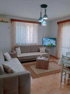 a living room with a couch and a table at Vangert Apartment in Berat