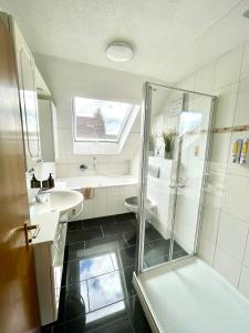 a bathroom with a shower and a sink at Ferienwohnung am Schwarzwald in Althengstett