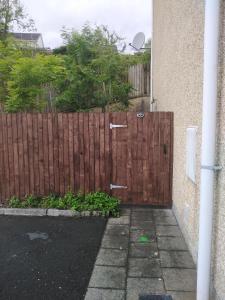 a wooden gate in front of a fence at Hillside Residence in Carrick on Shannon