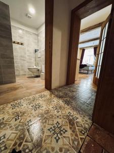 a bathroom with a toilet and a tile floor at Original Trebic whisky bar Room in Třebíč