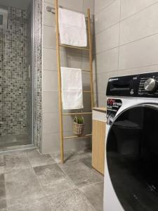 a bathroom with a towel rack and a washing machine at Olives Villa in Anopoli Sfakion