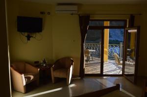 a living room with a door open to a balcony at Castle waterfront apartments in Dinoša