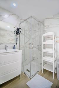 a bathroom with a shower with a sink and a toilet at Plazamar 6 Jose in Torre del Mar