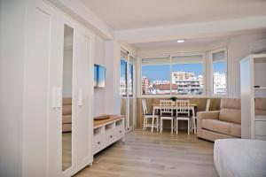 a bedroom with a bed and a dining room with a table at Plazamar 6 Jose in Torre del Mar
