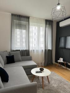 a living room with a couch and a table at Ocean Apartment in Zagreb