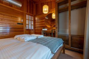 a bedroom with a bed in a wooden room at Naturelife Bungalows & SPA in Cıralı