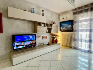a living room with a flat screen tv on a wall at Venice Travel Dream Spacious Apartment near Venice in Mestre