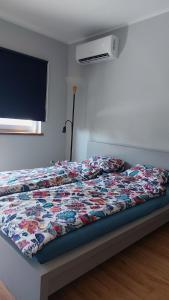a bed with a quilt on it in a bedroom at Apartament Polna Zator in Zator