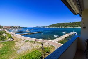 a view of the water from the balcony of a building at Apartments Darko by the sea in Supetarska Draga