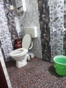 a bathroom with a toilet and a shower at Sahana Villa in New Hampi