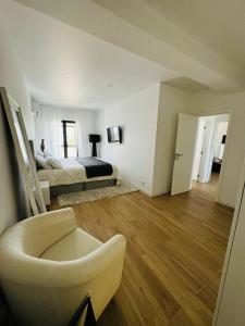 a bedroom with a bed and a chair in a room at Portimão holiday home by Kerum in Portimão