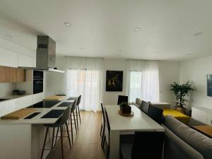 a kitchen and living room with a couch and a table at Portimão holiday home by Kerum in Portimão