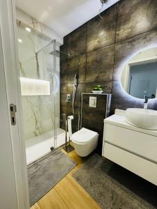 a bathroom with a toilet and a sink and a shower at Portimão holiday home by Kerum in Portimão +23 photos