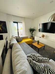 a living room with a couch and a television at Portimão holiday home by Kerum in Portimão