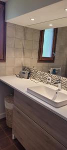 a bathroom with a sink and a mirror at Maison au calme, proche Chambéry in Vimines