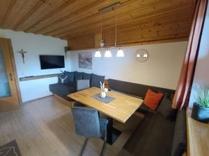 a dining room with a table and a couch at Appartements Anfang in Weerberg