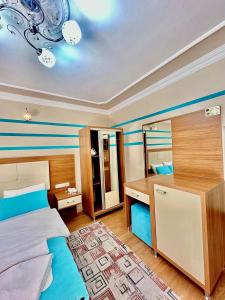 A bed or beds in a room at Konak Grand Apart
