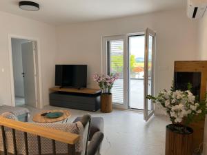 a living room with a couch and a table and a television at Villa Anna's heaven in Imotski