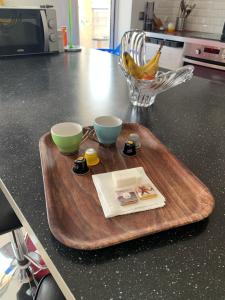a wooden cutting board with two bowls on top of a counter at Droit au but!! in Marseille