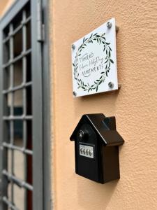 a sign on the side of a building with a bird mailbox at Casa dell' Artista - Tamerò Estates in Montopoli in Sabina