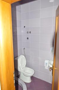 a bathroom with a toilet and a sink at Castle waterfront apartments in Dinoša +25 photos