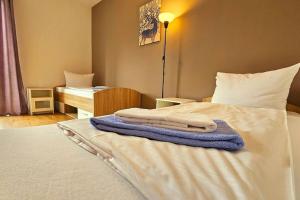 a bedroom with a bed with towels on it at Apartment number 4 in Oberschleißheim