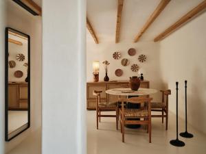 a dining room with a table and chairs at The Wild by Interni in Kalafatis