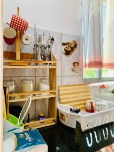 a kitchen with a sink and a shelf with utensils at Khalisee homes 2 bedroom apartment in Bamburi in Mombasa