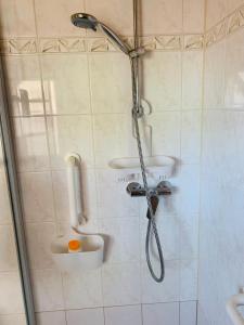 a shower in a bathroom with two sinks at Ferienwohnung Juttchen in Roßleben +53 photos