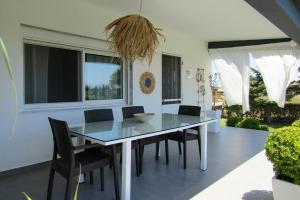 a dining room with a table and chairs at LefCoast SENSUS Apartments in Paralía Avdhíron