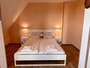 1 dormitorio con 1 cama blanca y 2 mesitas de noche en Your Room Primorsko en Primorsko
