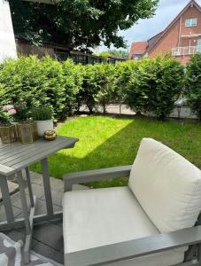 a white chair sitting next to a picnic table at Deluxe Apartement mit Terrasse in Duisburg