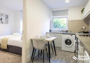 une cuisine et une chambre avec un lit et une table dans l'établissement One Bedroom Apartment At Smooth Stays Short Lets & Serviced Accommodation Preston With Parking Near Train Station, à Preston