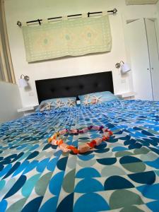 a bedroom with a bed with a blue and white comforter at Dolce Bungalow R5915 in Pula +23 photos