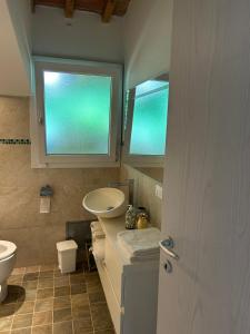 a bathroom with a sink and a toilet and a window at Vacanze toscane Relax privacy in San Baronto +36 photos