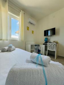 Postel nebo postele na pokoji v ubytování Sirio rooms and apartments