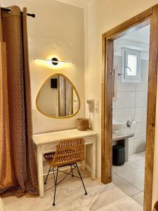a bathroom with a sink and a mirror at Athina Rooms - Lounge Apartments in Parikia