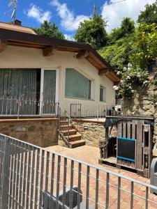 a house with a fence in front of it at Vacanze toscane Relax privacy in San Baronto
