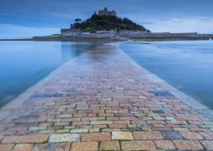 a brick pathway leading to an island in the water at Stream Valley Holiday Park in Penzance
