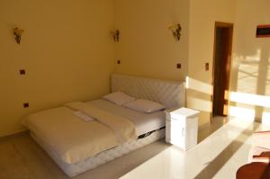 a bed in a room with a white bed frame at Castle waterfront apartments in Dinoša