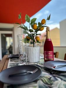 a table with a plate and a bottle of wine at Very Cozy Apartment at ARED Arad in Arad