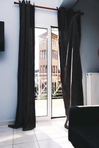 a room with a window with black curtains at Gk Suites-Constantin view , auto check-in 24h in Larisa