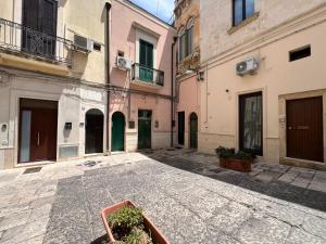 an empty street in an alley with buildings at Handy Pergola in Brindisi